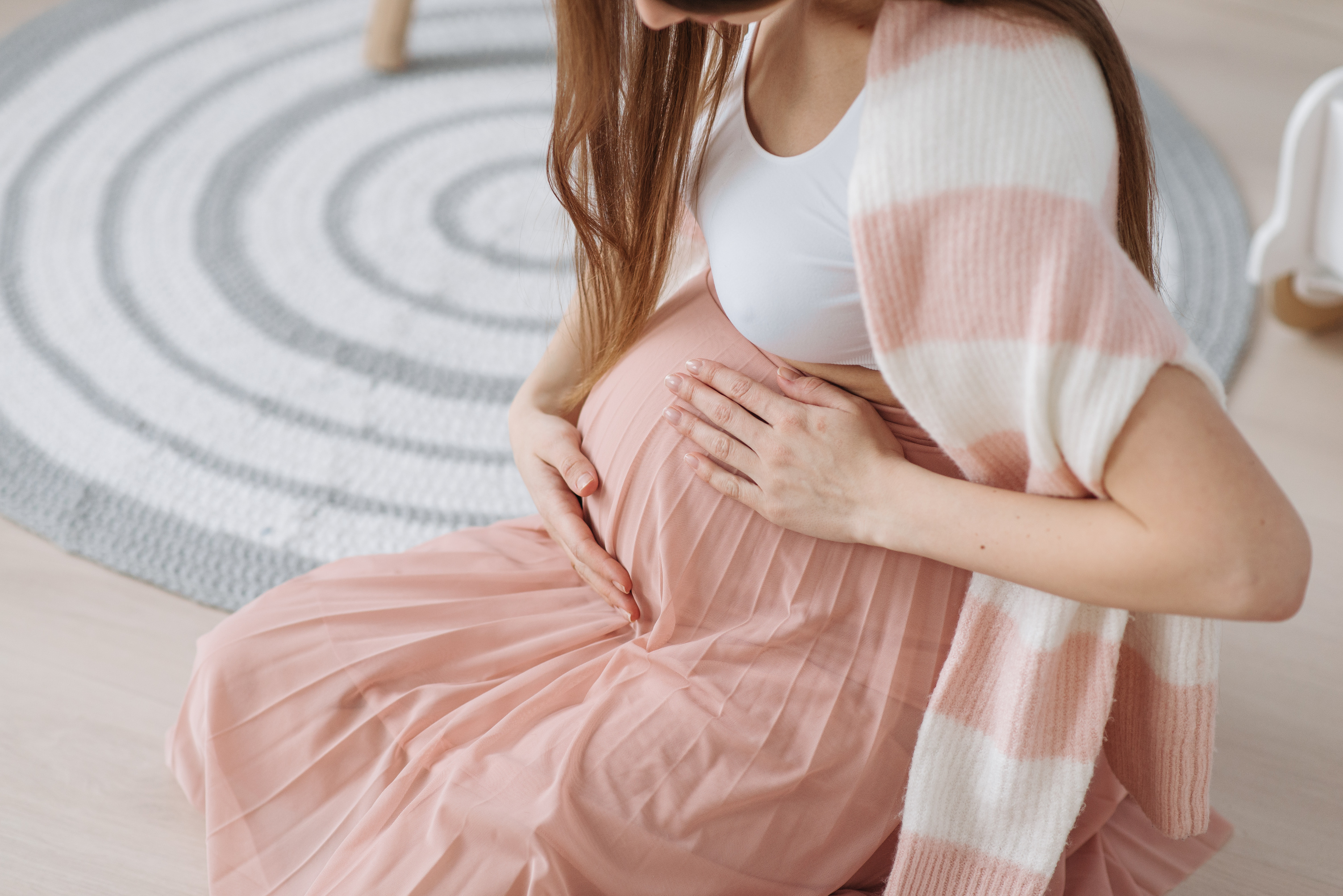 An Expectant Mother Rubbing Her Pregnant Belly